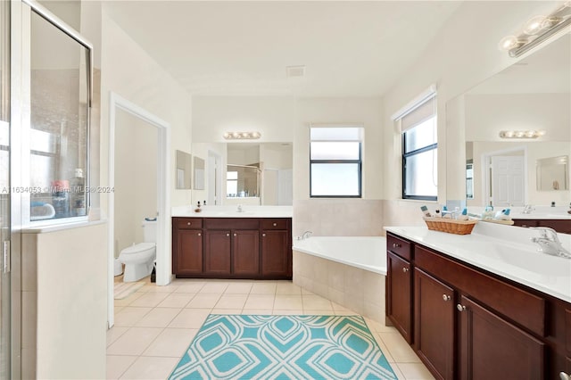 bathroom featuring tile patterned flooring, independent shower and bath, dual vanity, and a bidet