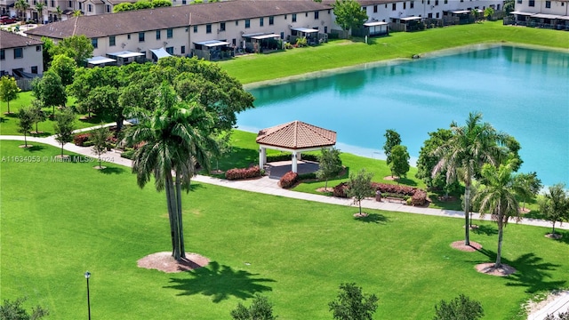 surrounding community featuring a yard and a water view