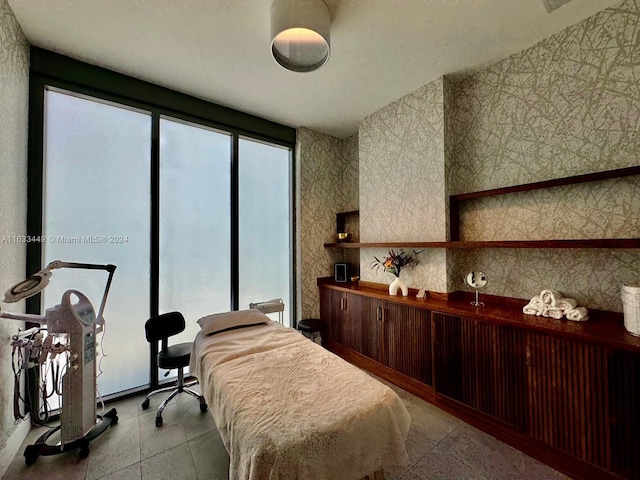 bedroom with multiple windows and light tile patterned floors