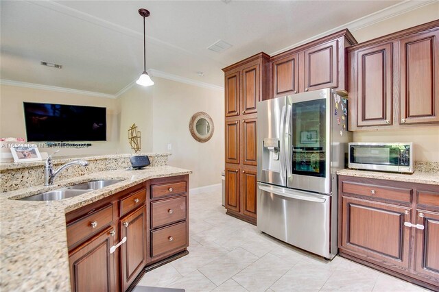 kitchen featuring light tile patterned floors, stainless steel appliances, hanging light fixtures, sink, and ornamental molding