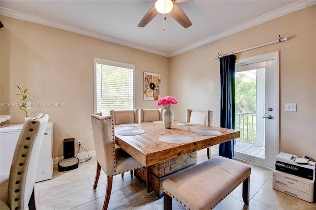 tiled dining area featuring crown molding and ceiling fan