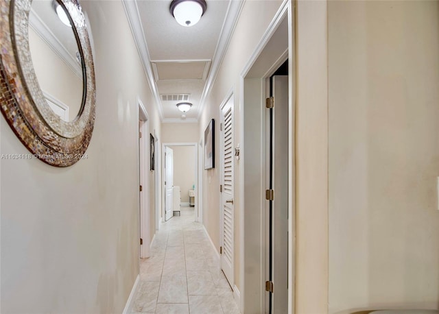 hall featuring ornamental molding, light tile patterned flooring, and a textured ceiling