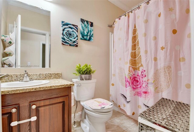 bathroom with tile patterned floors, crown molding, toilet, and vanity