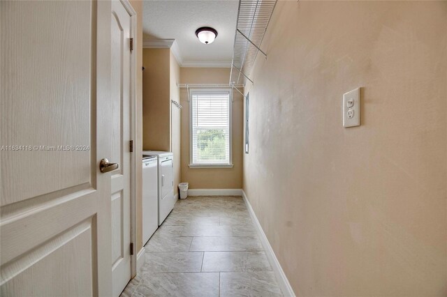 hall with washer and dryer, a textured ceiling, light tile patterned floors, and crown molding