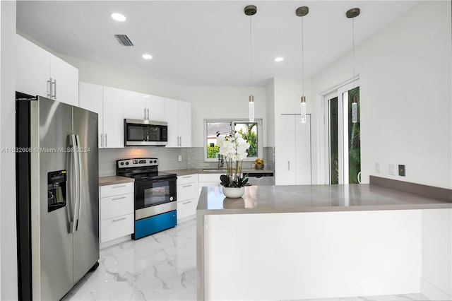 kitchen featuring a wealth of natural light, white cabinetry, and stainless steel appliances