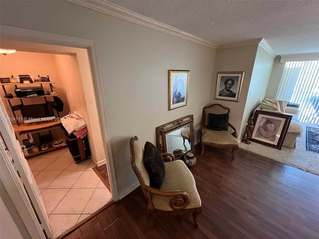 hallway featuring ornamental molding, a textured ceiling, and tile patterned floors