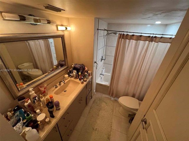 full bathroom with shower / bath combo with shower curtain, toilet, vanity, and tile patterned flooring