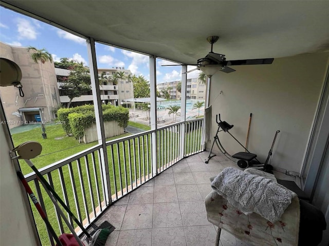 sunroom / solarium featuring ceiling fan