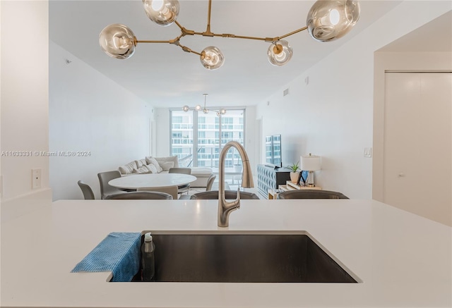 kitchen with sink, decorative light fixtures, and floor to ceiling windows