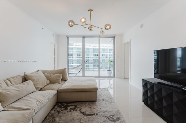 tiled living room featuring a notable chandelier and expansive windows