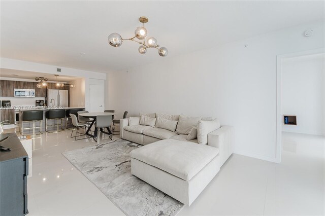 living room with a notable chandelier and light tile patterned floors