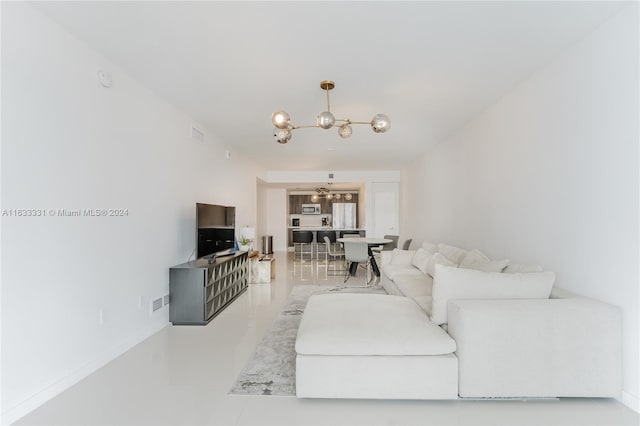 living room featuring tile patterned floors and a notable chandelier