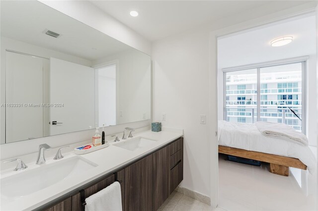 bathroom featuring tile patterned flooring and dual vanity