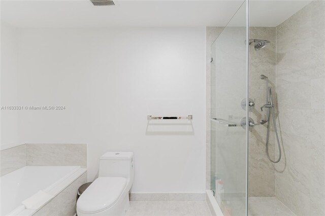 bathroom with tile patterned floors, a shower with door, and toilet