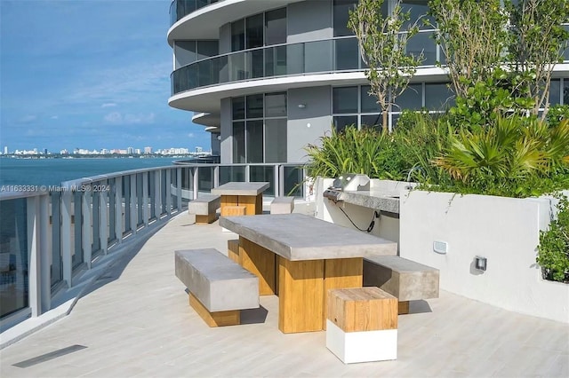 exterior space with a balcony and a water view