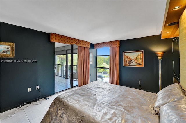 bedroom with access to exterior and light tile patterned floors