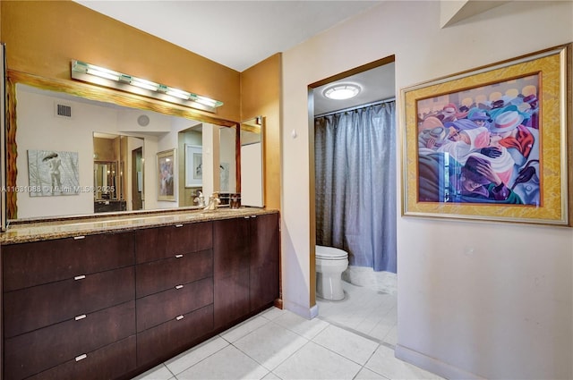 bathroom with vanity, toilet, and tile patterned flooring