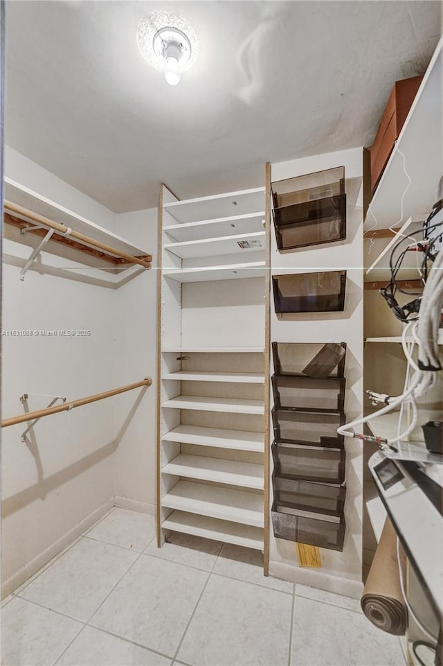 spacious closet with light tile patterned flooring