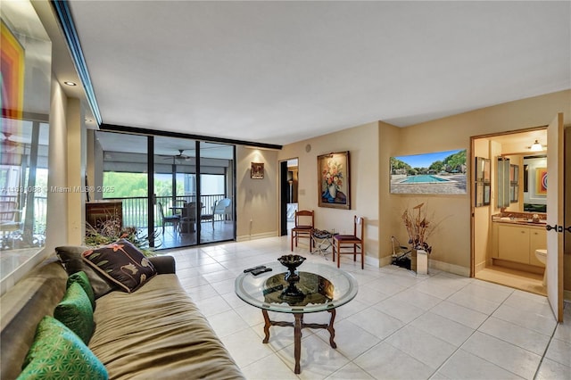 living room with light tile patterned floors and a wall of windows