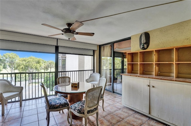 sunroom with ceiling fan and plenty of natural light