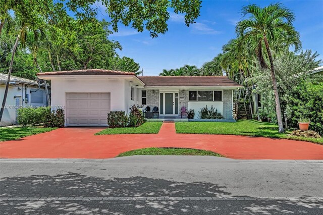 view of front of property featuring a garage and a front yard