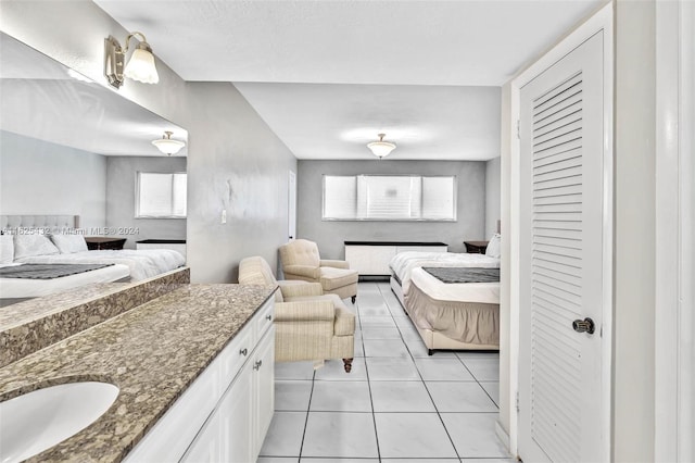 tiled bedroom featuring sink