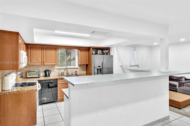 kitchen with sink, tasteful backsplash, stainless steel fridge with ice dispenser, light tile patterned floors, and dishwasher