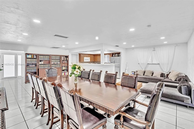 tiled dining area with a textured ceiling