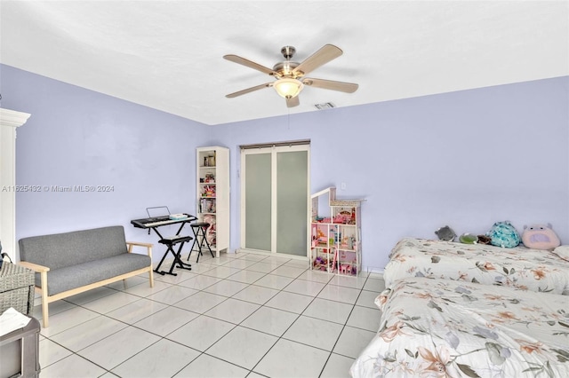 tiled bedroom featuring a closet and ceiling fan