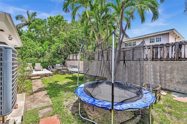 view of yard featuring a patio and a trampoline