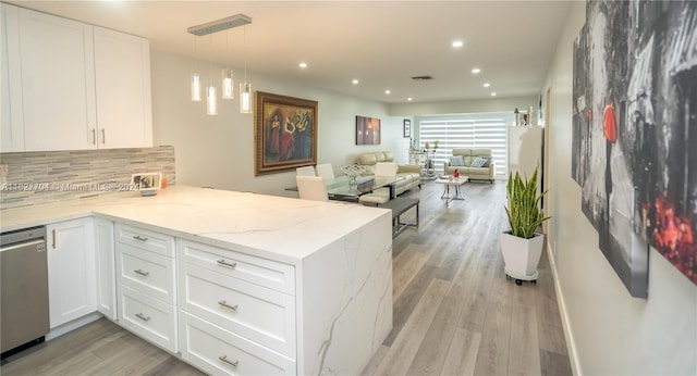 kitchen with white cabinetry, dishwasher, light stone counters, light hardwood / wood-style flooring, and kitchen peninsula