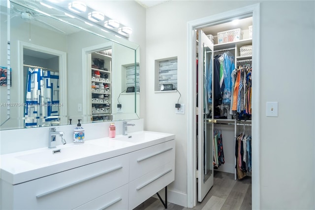 bathroom with wood-type flooring and double sink vanity