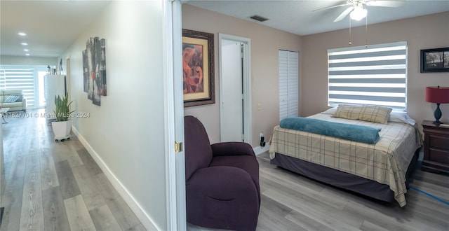 bedroom featuring light wood-type flooring and ceiling fan