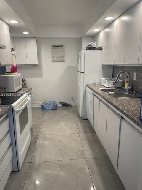 2401 S Ocean Dr Unit 1203, Hollywood, FL 33019 - kitchen with light tile patterned flooring, sink, backsplash, white cabinets, and white appliances