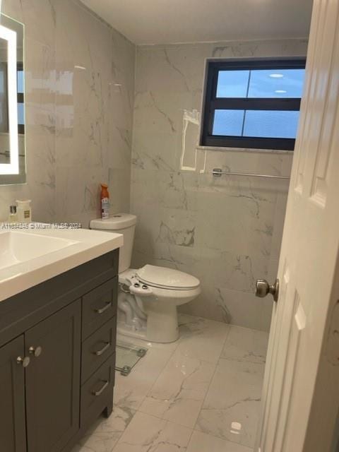 2401 S Ocean Dr Unit 1203, Hollywood, FL 33019 - bathroom with vanity, tile walls, and toilet