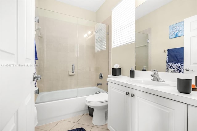 full bathroom with tile patterned flooring, vanity, toilet, and shower / bath combination with glass door