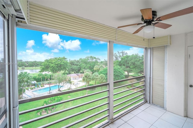 balcony with ceiling fan and a water view