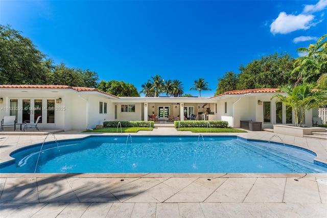 view of pool with pool water feature and a patio