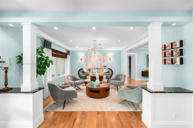 living area with light wood finished floors, recessed lighting, ornate columns, and crown molding