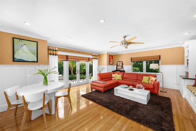 living area featuring recessed lighting, ornamental molding, wainscoting, light wood-style flooring, and ceiling fan