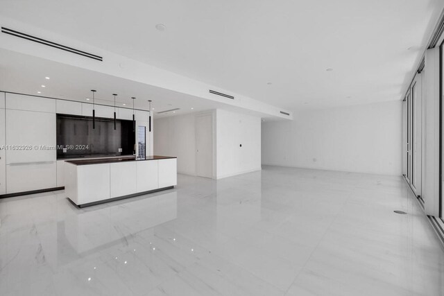 kitchen with sink, a center island, and light tile patterned flooring