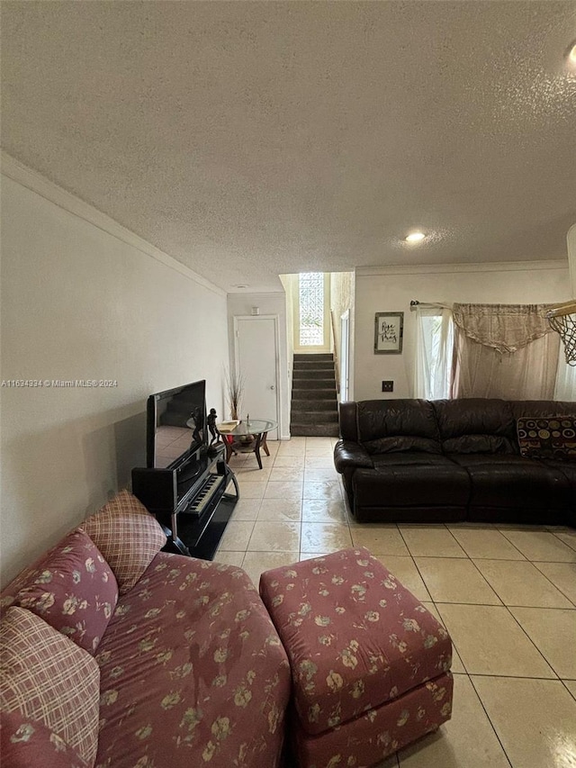 tiled living room with crown molding and a textured ceiling