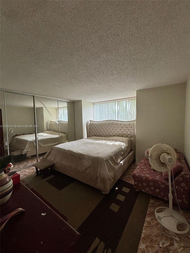 bedroom featuring carpet and a textured ceiling