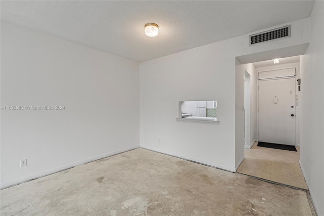 empty room featuring unfinished concrete floors and visible vents