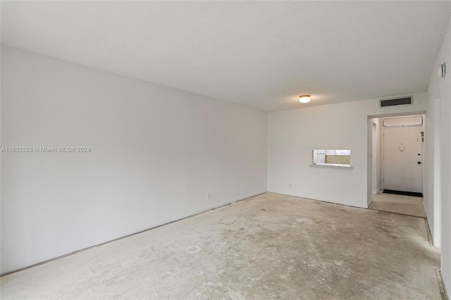 unfurnished room with visible vents and unfinished concrete floors