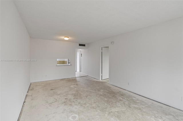 empty room featuring concrete floors and visible vents