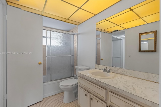 full bathroom with vanity, tile patterned flooring, shower / bath combination with glass door, and toilet