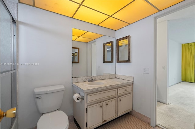 bathroom featuring vanity, tile patterned flooring, and toilet