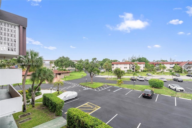 uncovered parking lot featuring a residential view