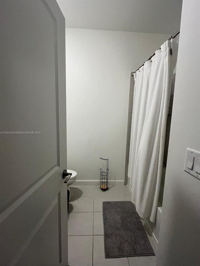 bathroom featuring tile patterned flooring and toilet